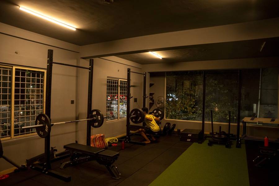 Wide view of the squat racks, benches and turf lane inside the UnReal gym, NGEF Layout, Kasturi Nagar