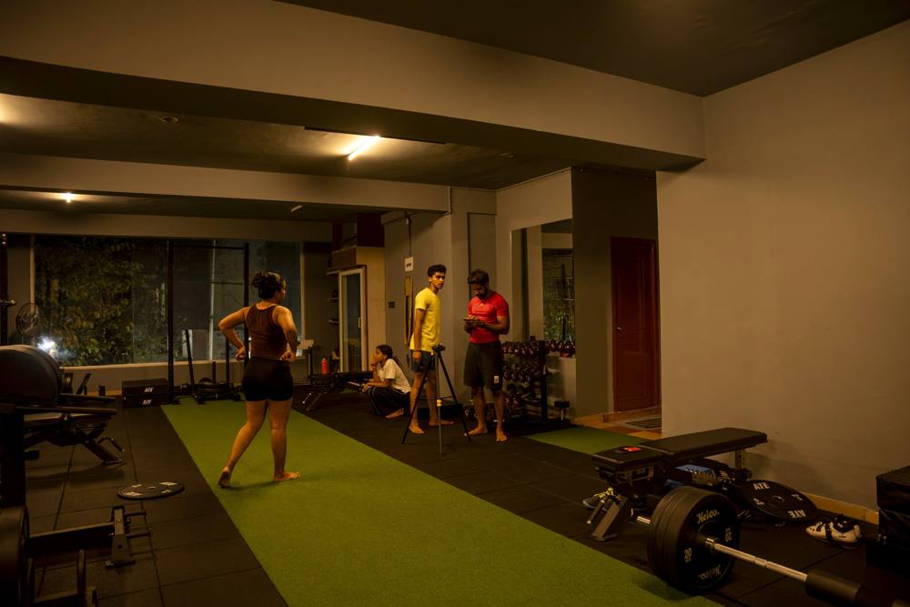 Athletes warming up on the turf sprint lane before an athlete performance training session