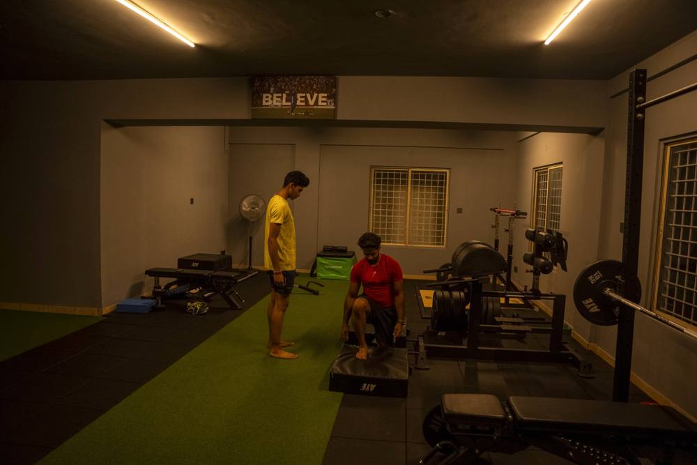 Coach demonstrating a plyometric box drill during return-to-sport training after injury